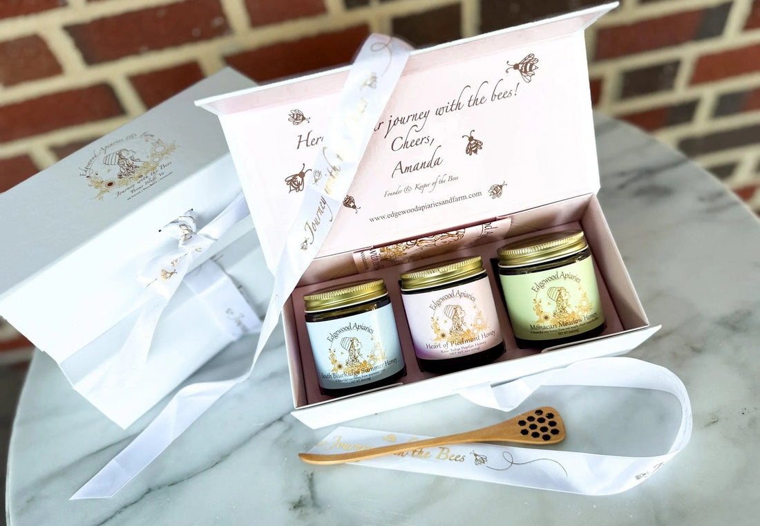 Edgewood Apiaries Virginia Honey Flight gift box: three 6 oz raw Virginia honey jars with gold lids and a bamboo dipper on marble.