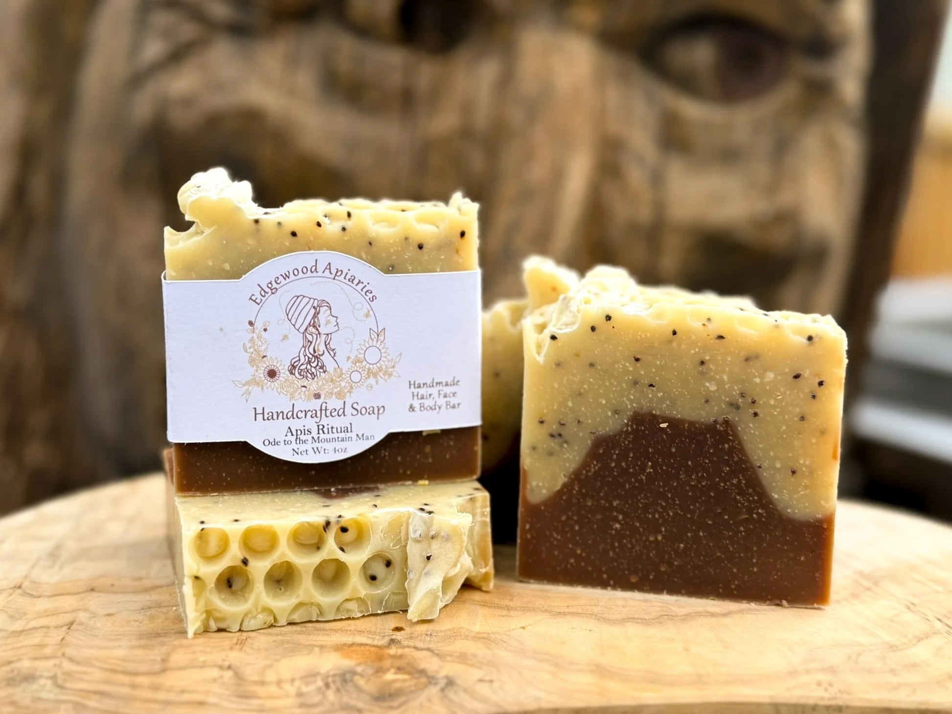 Edgewood Apiaries Apis Ritual Handcrafted Hair, Face and Body Bar on wood shelf in front of wood carving