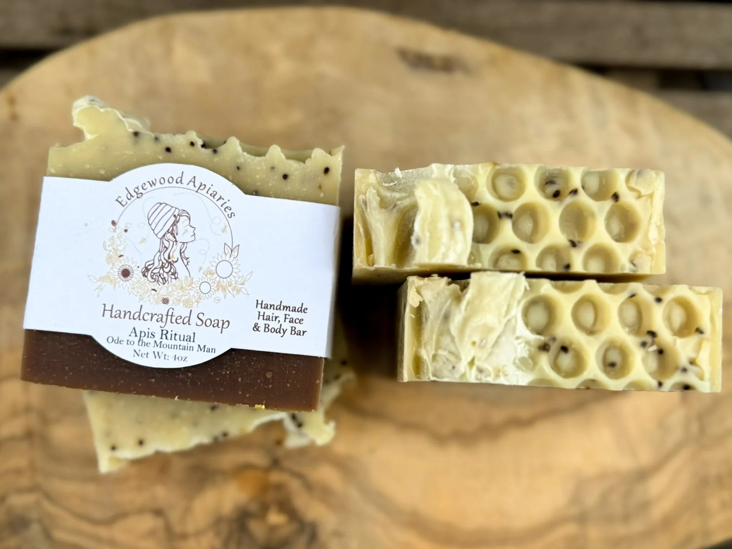 Edgewood Apiaries Apis Ritual Handcrafted Hair, Face and Body Bar laying down on wooden shelf