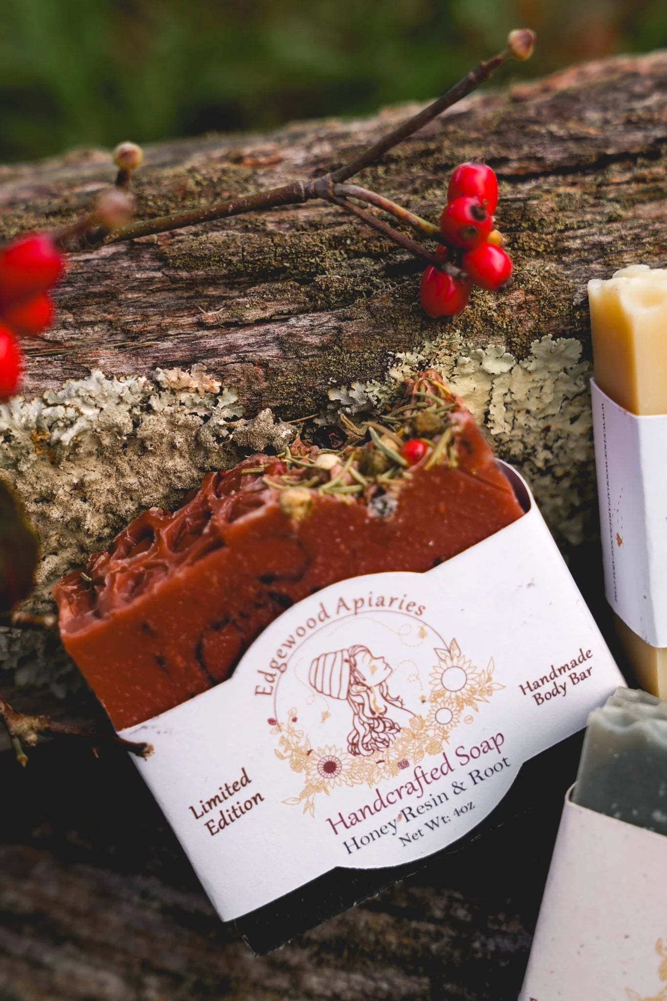 Edgewood Apiaries Honey Resin and Root Handcrafted Body Soap Bar on a wooden background with festive berries
