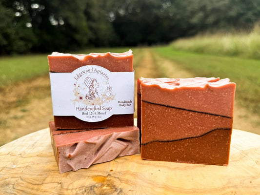 Edgewood Apiaries Red Dirt Road Handcrafted Body Soap Bar on wooden platform with a Virginia red dirt road background