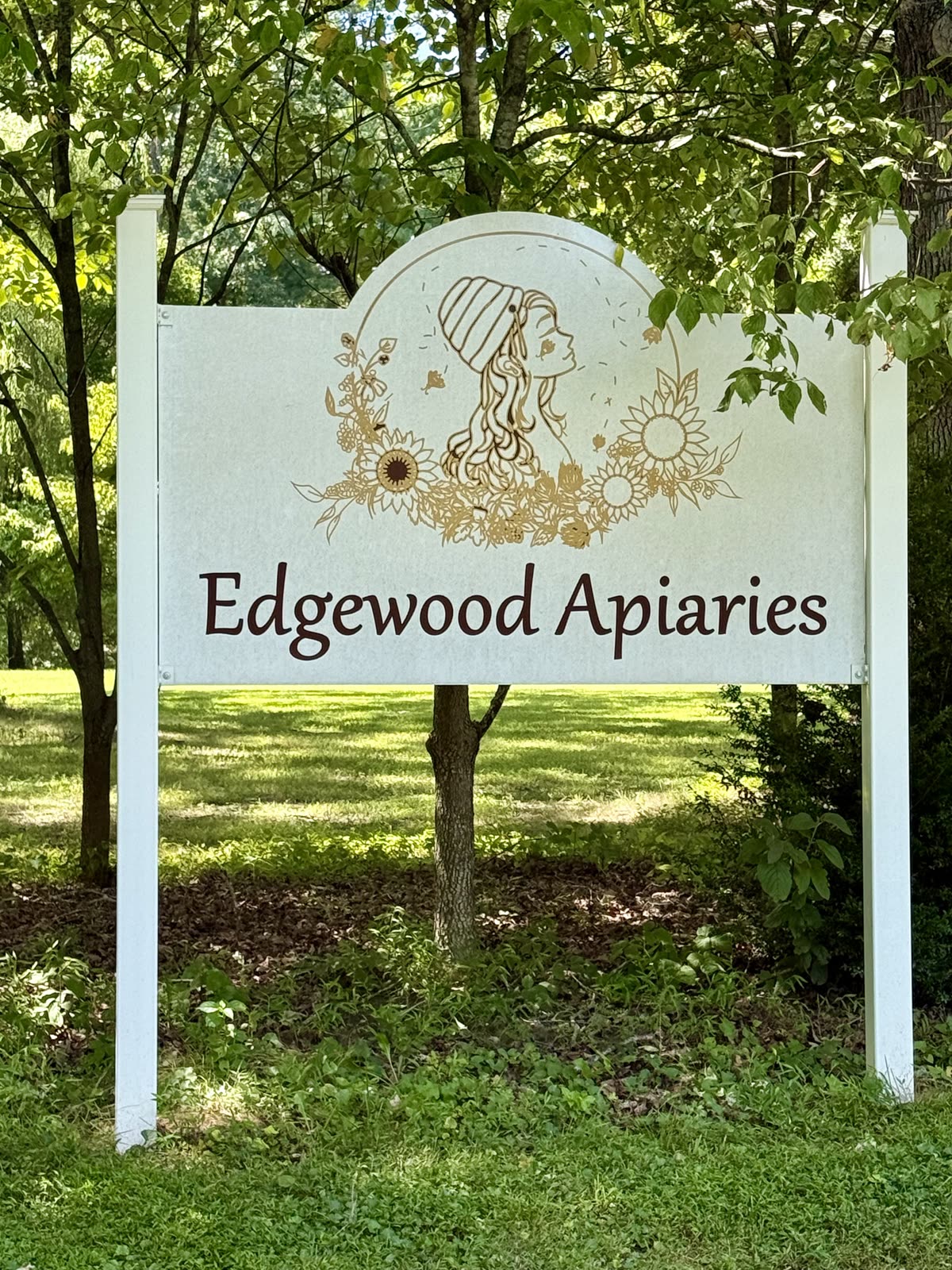 Edgewood Apiaries & Farm roadside sign at 3456 James Madison Highway, Bremo Bluff, Virginia. White farm sign with the woman-and-bees mark.