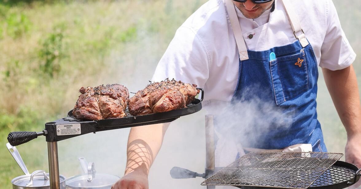 Outdoor live-fire cooking at Ember & Earth, the Root to Table event covered by the Winchester Star.